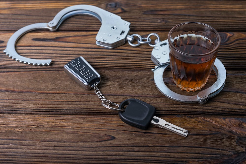 car keys next to handcuffs on a table