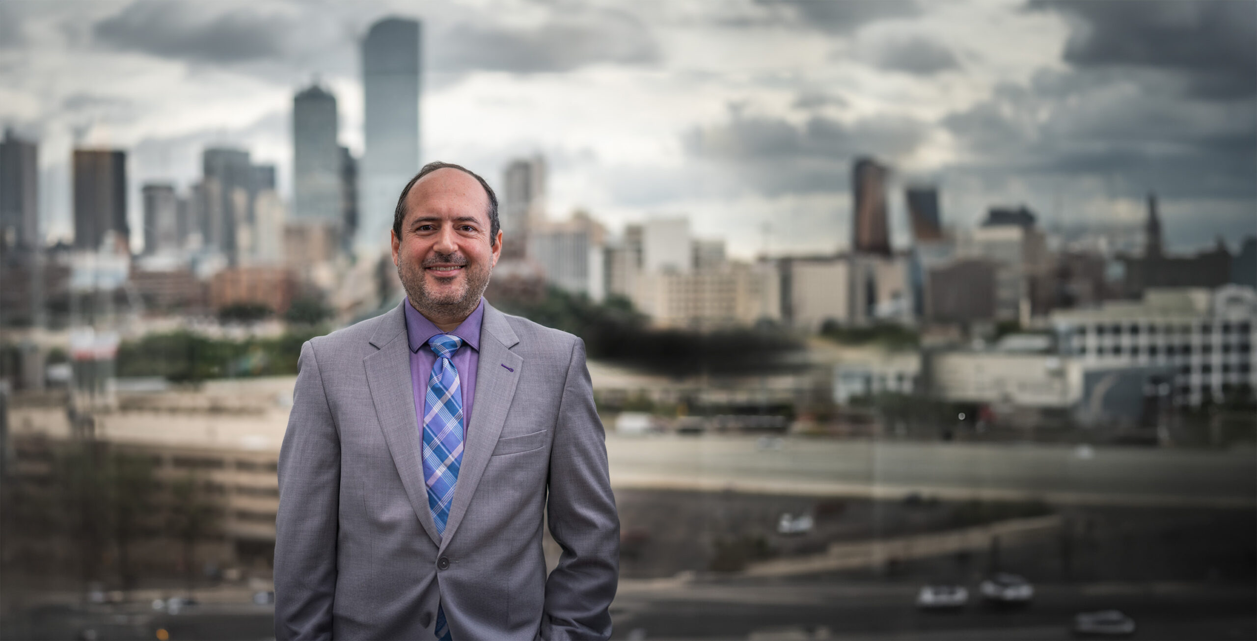 hero jim in front of dallas skyline scaled