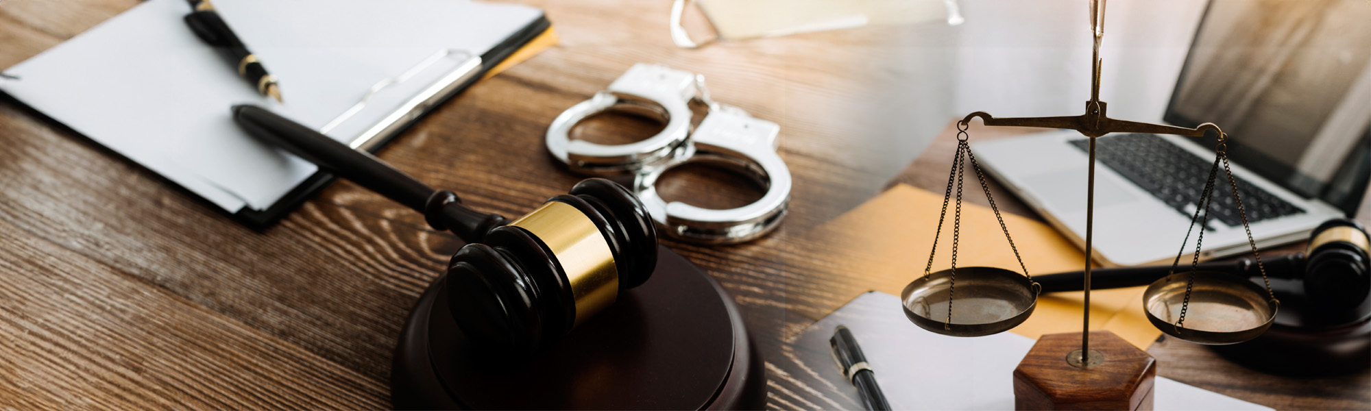 collage of gavel scales and laptop on desk - Dallas County Criminal Lawyer concept image