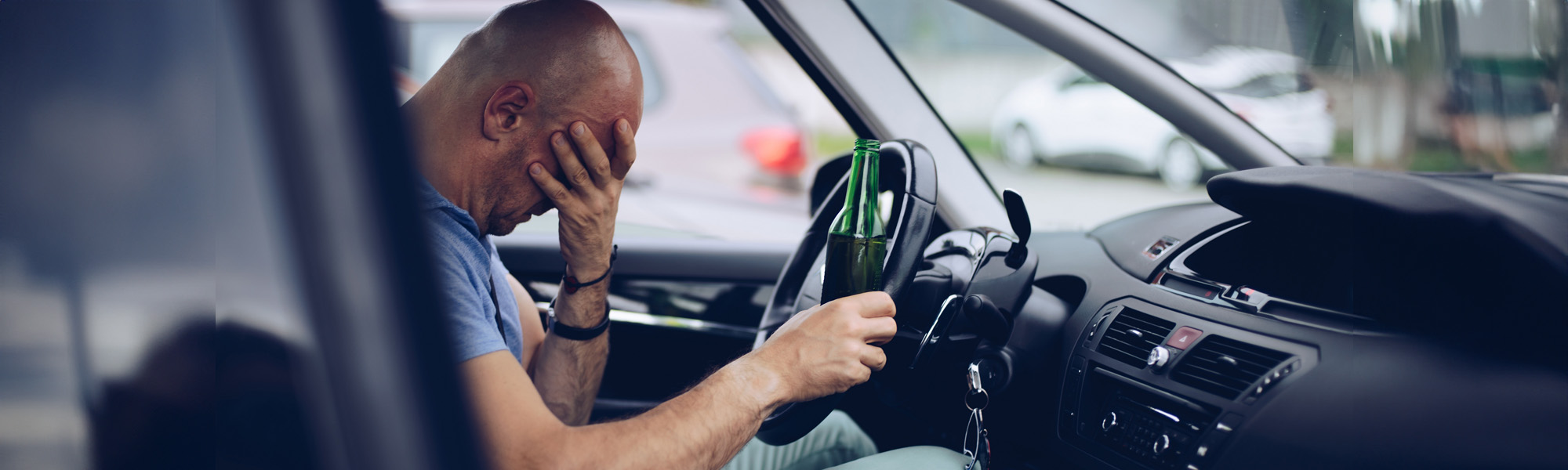 drunk driver drinking alcohol in car