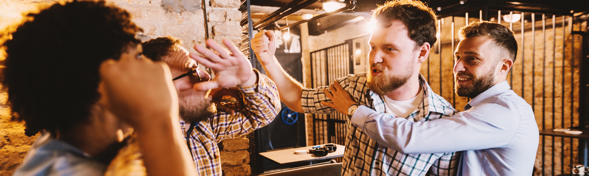 group of drunk men starting a fight in pub