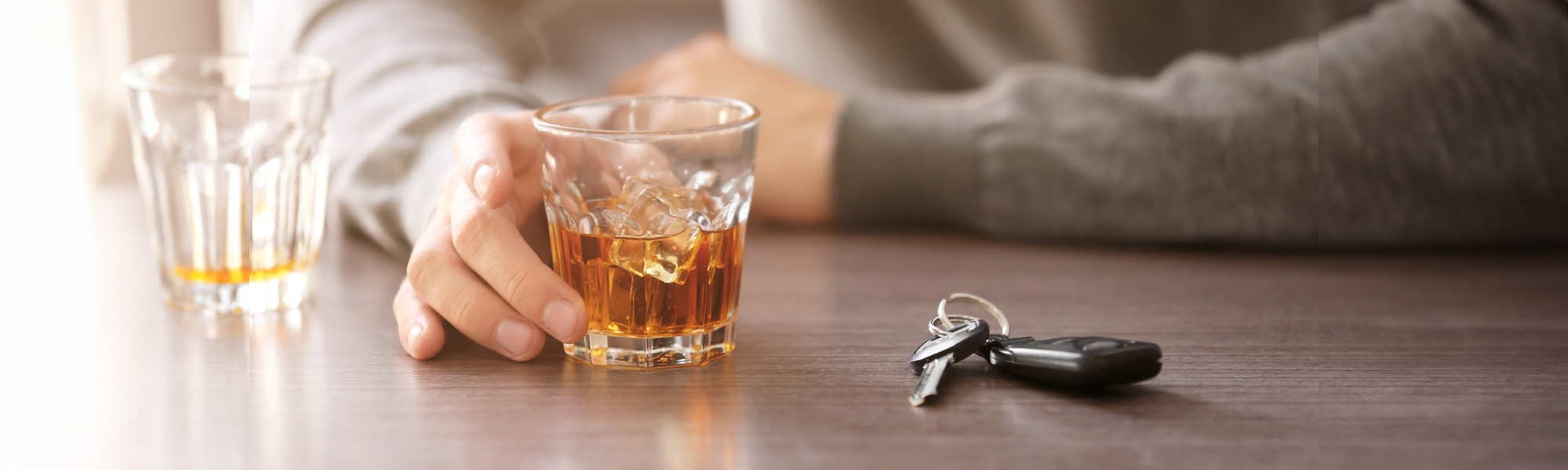 drunk man with car key and alcoholic beverage in bar