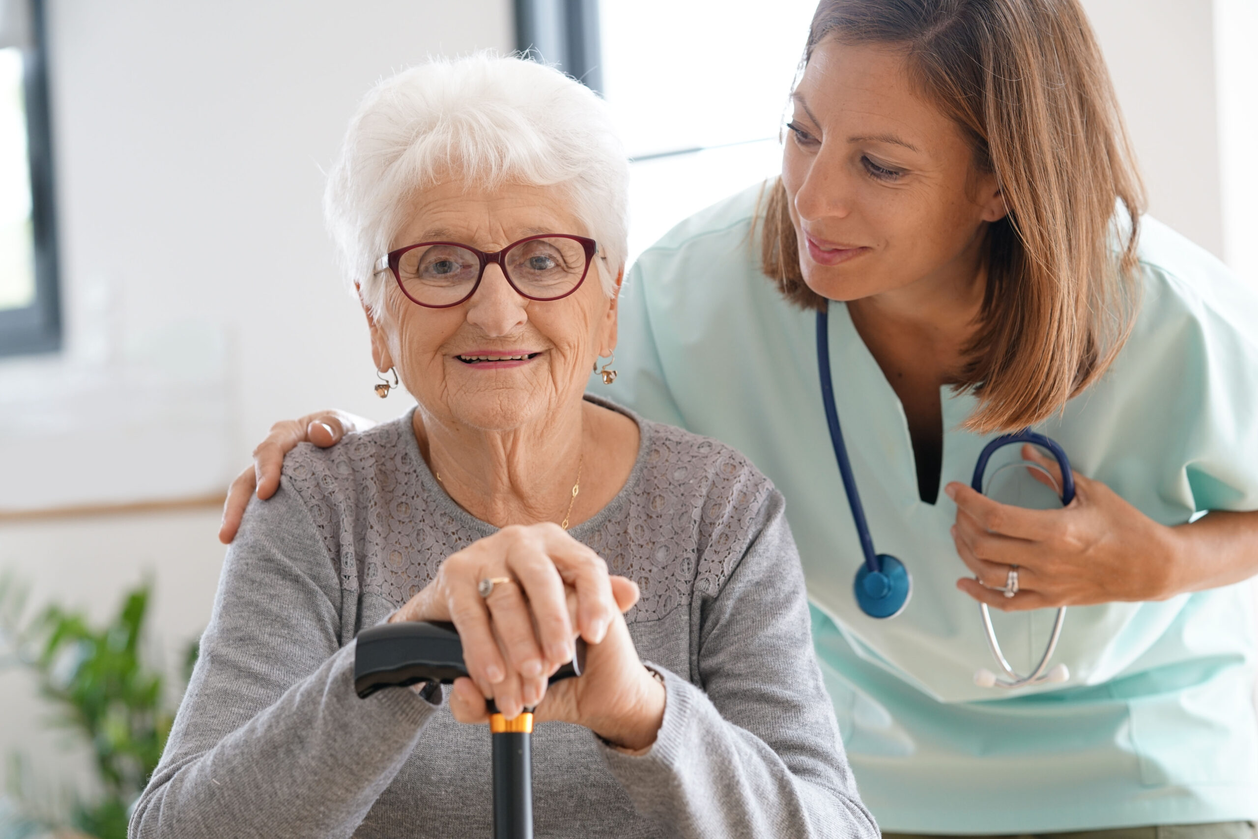 Nurse visiting old woman at home