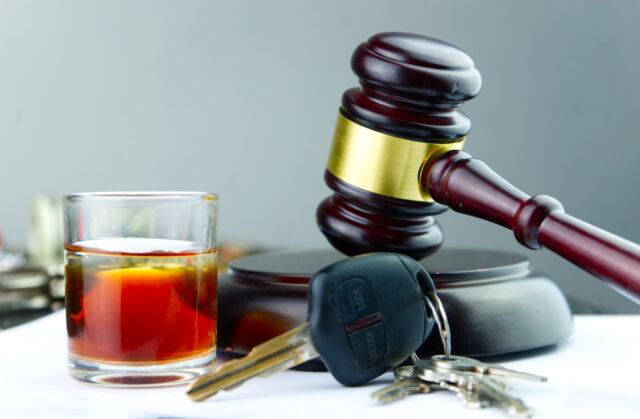 alcoholic beverage in glass car keys and gavel