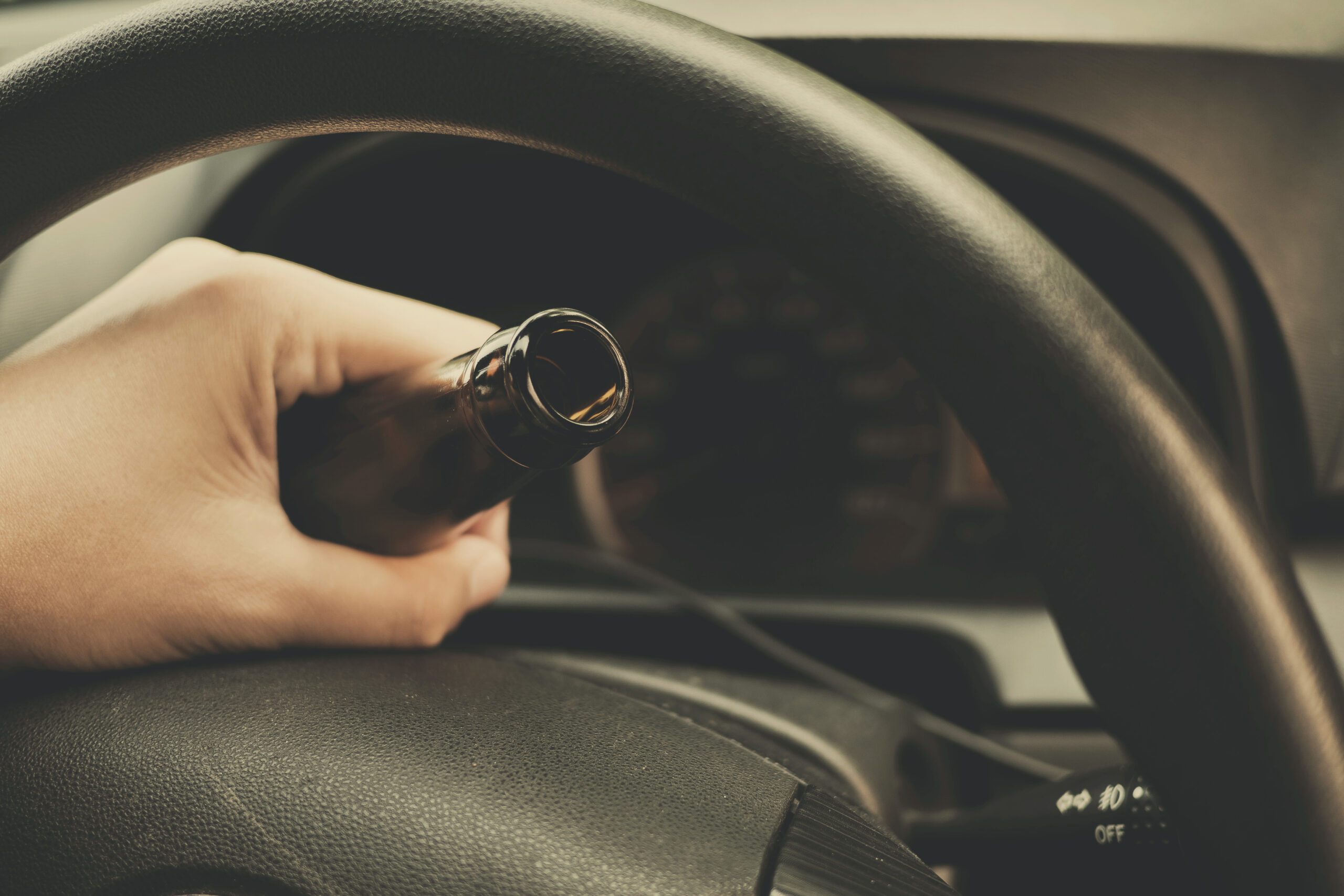 Man drink beer while driving car. Driving in a state of intoxication.don't drink and drive concept