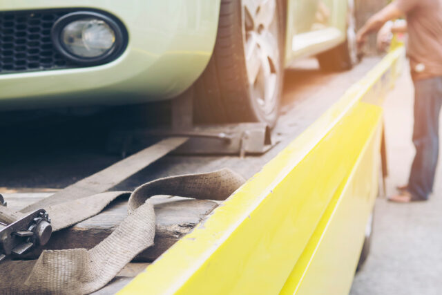 car transporter breakdown lorry during working using locked belt transport other green car